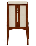 Wooden chair with a white cushion on a white background