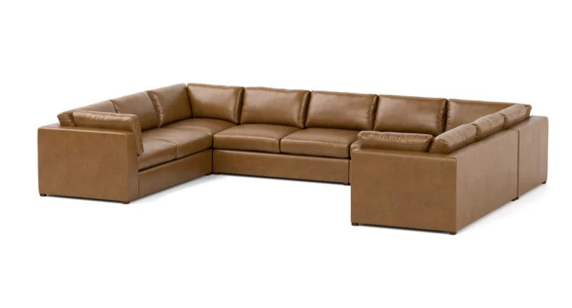 A modern L-shaped sectional sofa upholstered in smooth tan leather, shown from a three-quarter angle against a plain white background.