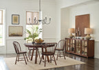 Dining room with wooden table and chairs, chandelier, and sideboard.
