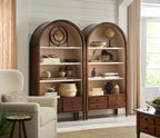 Wooden arched bookshelves in a living room setting with decor items.