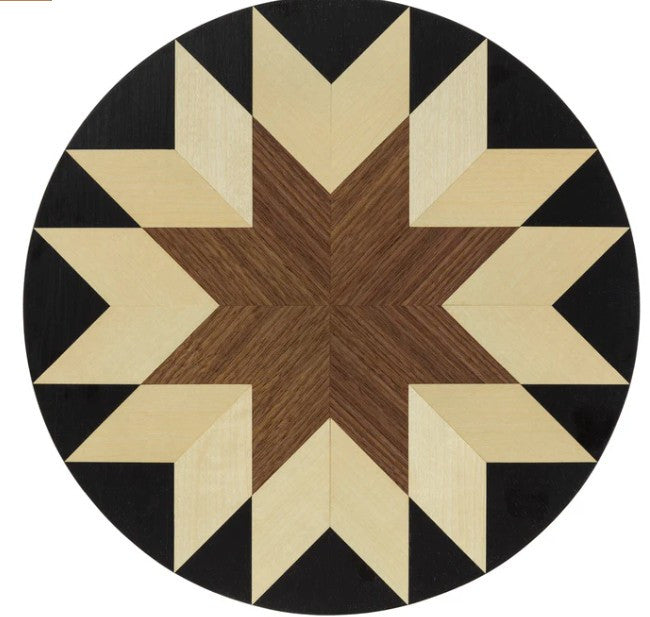 Round wooden table with a star pattern.