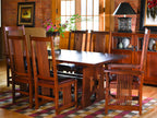 Wooden dining table with chairs in a room with a checkered floor and wooden walls.