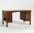 A dark brown wooden writing desk with a slatted panel design on the legs, featuring two drawers on the front, set against a plain light gray background.