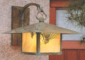 Vintage-style wall-mounted light fixture with a warm glow on a textured wall.