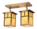 Pair of brass ceiling lights with glass shades on a white background