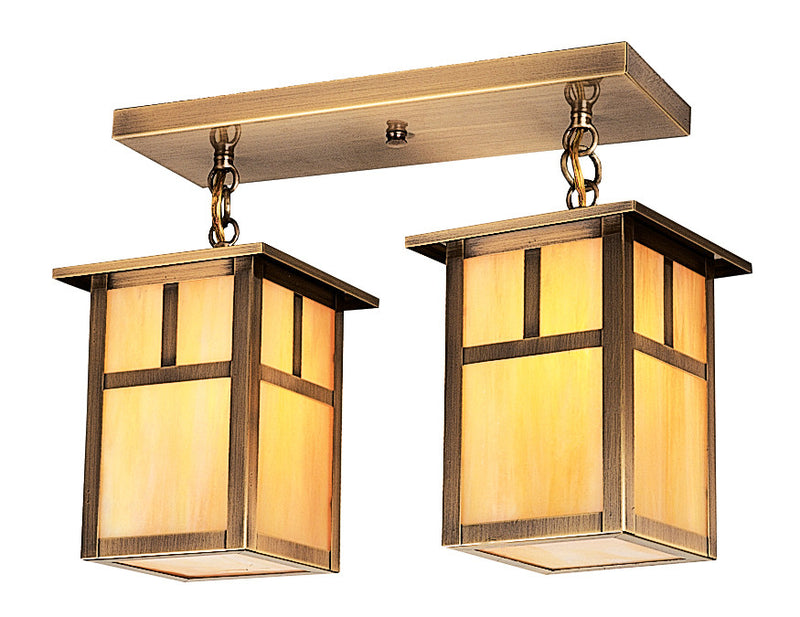 Pair of brass ceiling lights with glass shades on a white background