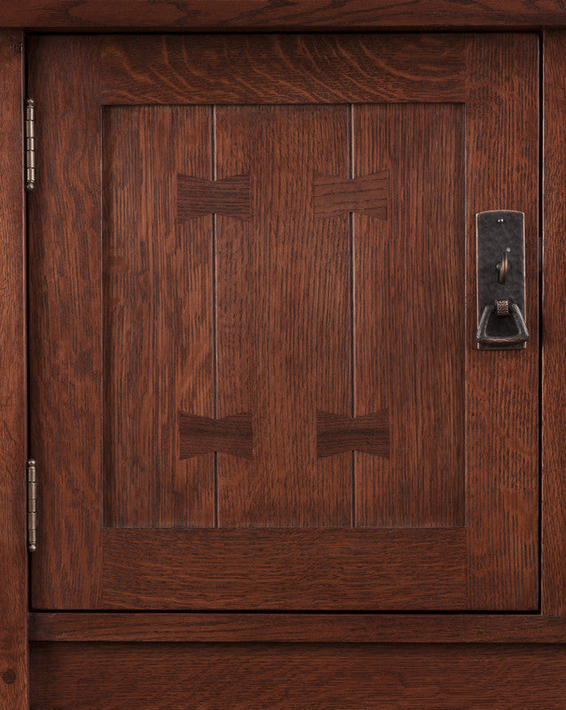 Close-up of a wooden cabinet door with a handle for the Stickley Mission Sideboard. 