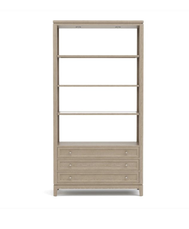 Beige bookshelf with open shelves and a drawer on a white background