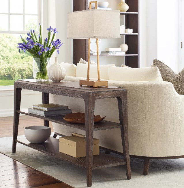 Living room with a wooden console table, beige sofa, and decorative items.