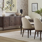 Dining room with wooden sideboard, chairs, and decorative elements.