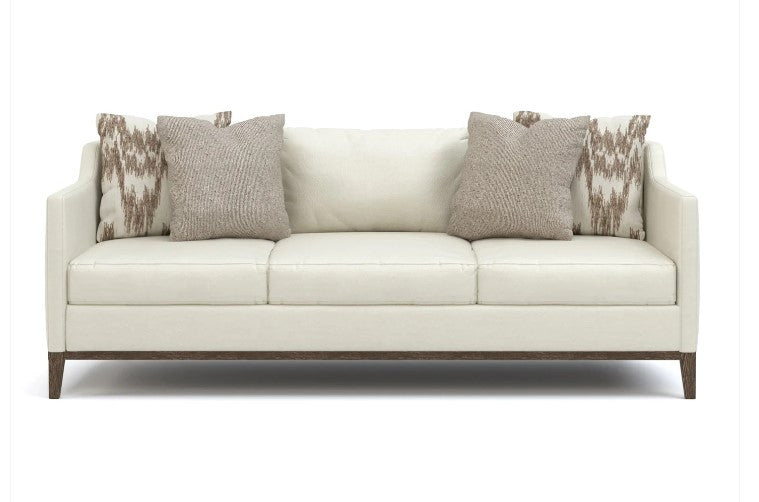 White sofa with patterned cushions on a white background