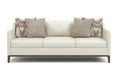 White sofa with patterned cushions on a white background