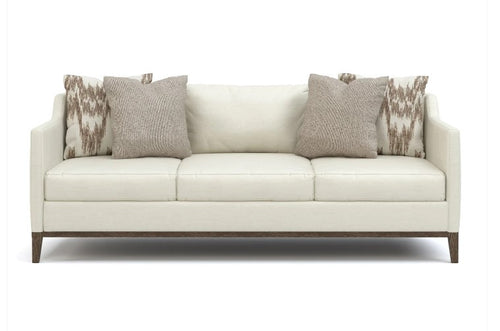White sofa with patterned cushions on a white background