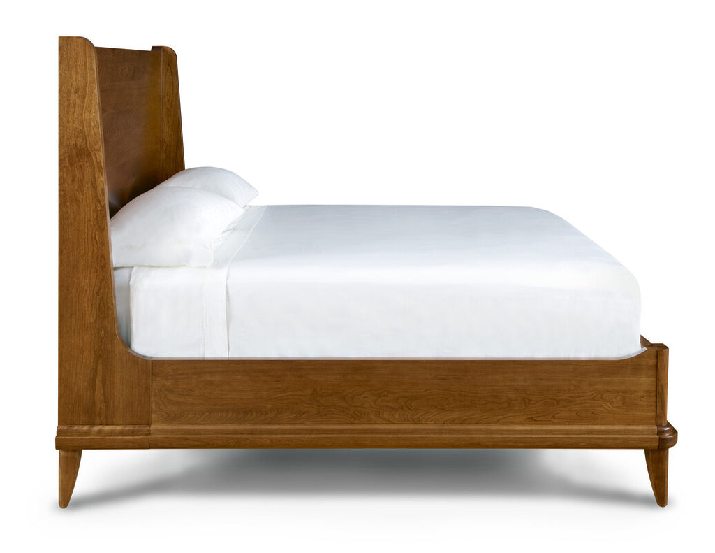 Wooden bed frame with white bedding on a white background