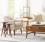 Modern living room with beige armchair, wooden coffee table, and side tables.