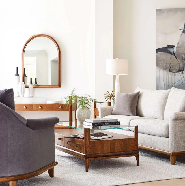 Modern living room with gray sofa, armchair, and wooden coffee table.