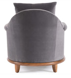 Gray velvet armchair with wooden legs on a white background