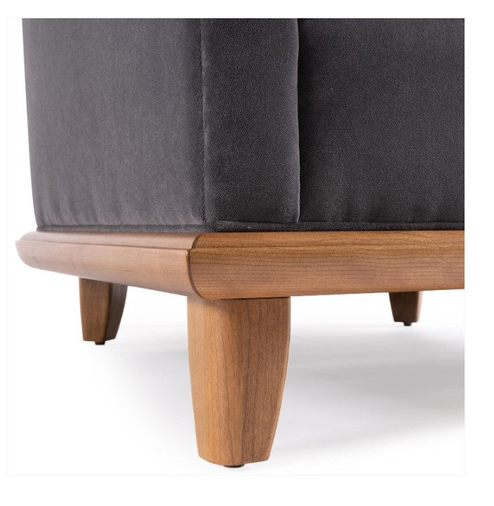 Gray upholstered chair with wooden legs on a white background