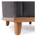 Gray upholstered chair with wooden legs on a white background