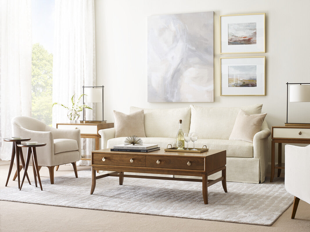 Modern living room with beige sofa, armchair, and wooden coffee table.