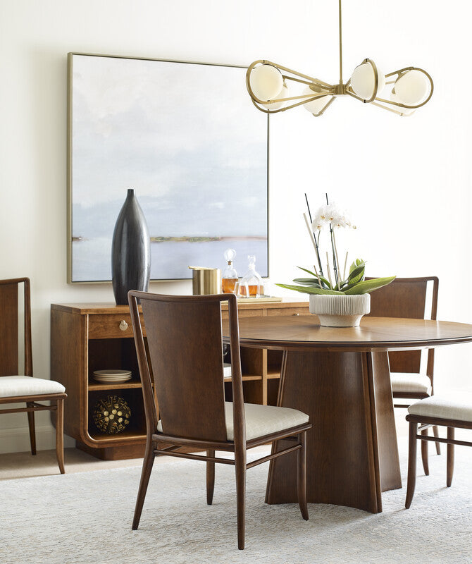 Dining room with wooden table, chairs, and decorative elements.