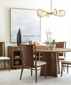 Dining room with wooden table, chairs, and decorative elements.