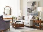 Modern living room with gray sofa, wooden coffee table, and abstract art on wall.