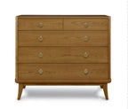 Wooden dresser with four drawers and brass knobs on a white background