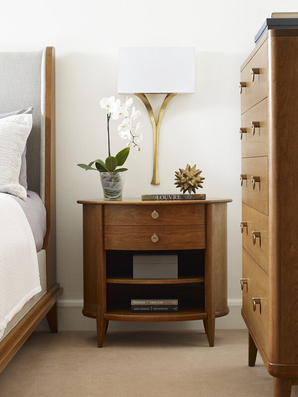 Wooden nightstand with decorative items in a bedroom setting