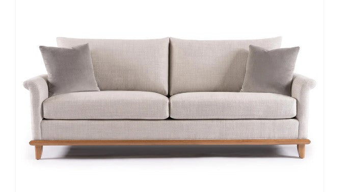 Light gray sofa with wooden legs on a white background