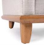 Close-up of a sofa with wooden legs on a white background