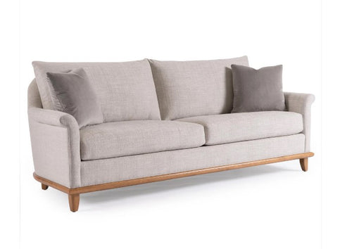 Gray sofa with wooden legs on a white background