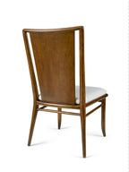 Wooden chair with a white cushion on a white background
