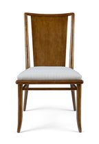 Wooden chair with a white cushion on a white background