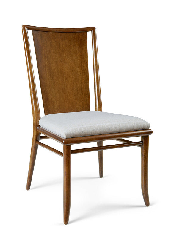 Wooden chair with a white cushion on a white background
