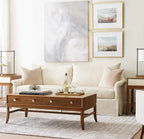 Living room with beige sofa, wooden coffee table, and framed artwork on the wall.