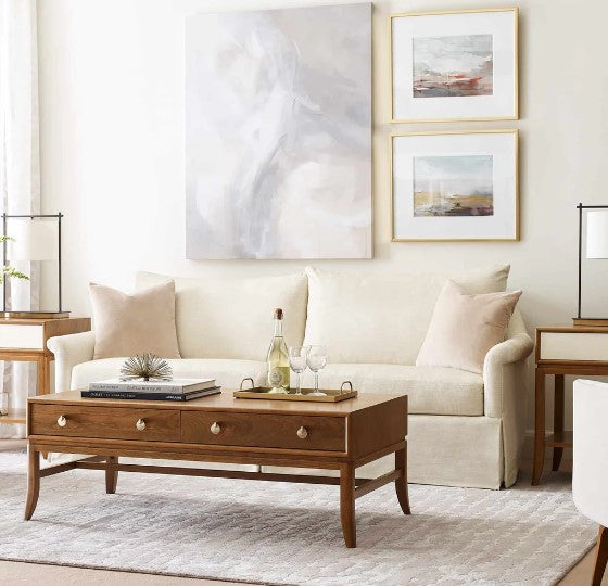 Living room with beige sofa, wooden coffee table, and framed artwork on the wall.