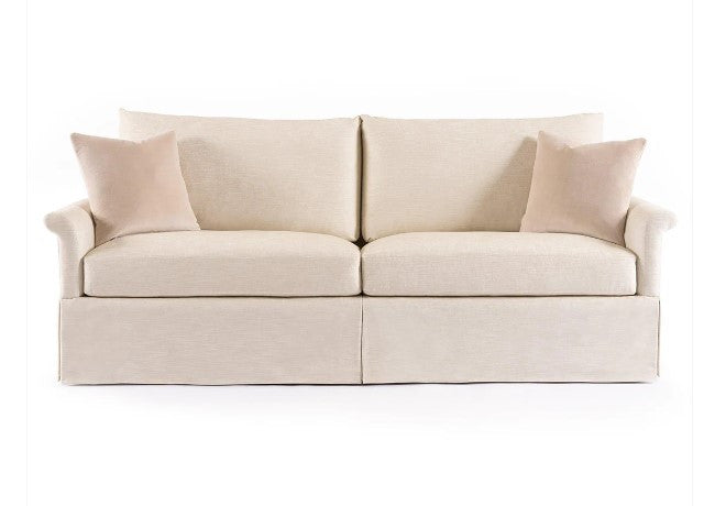 Beige sofa with two cushions on a white background