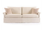 Beige sofa with two cushions on a white background