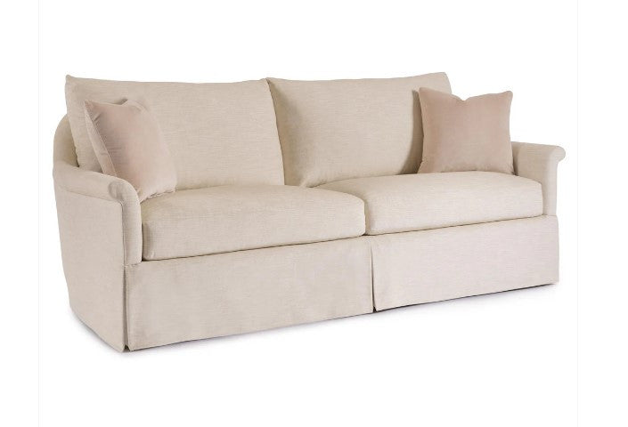 Beige sofa with three cushions on a white background