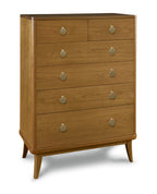 Wooden dresser with six drawers and round metallic handles on a white background
