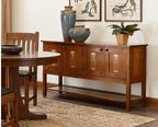 Wooden dining table and sideboard with decorative items in a room setting.