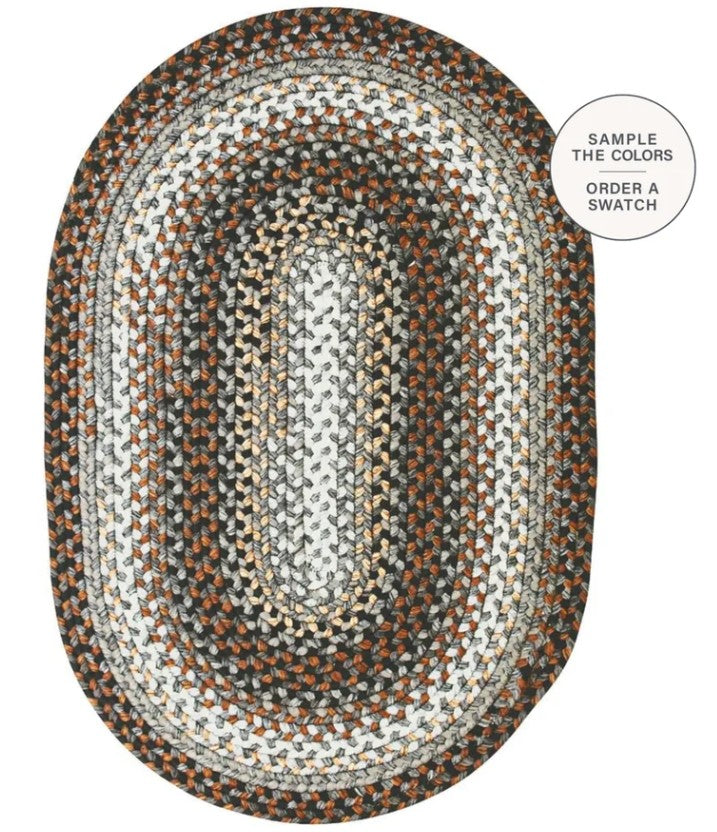 An oval braided area rug with concentric bands of white, gray, beige, and rust brown, shown on a white background with a circular callout in the top right.