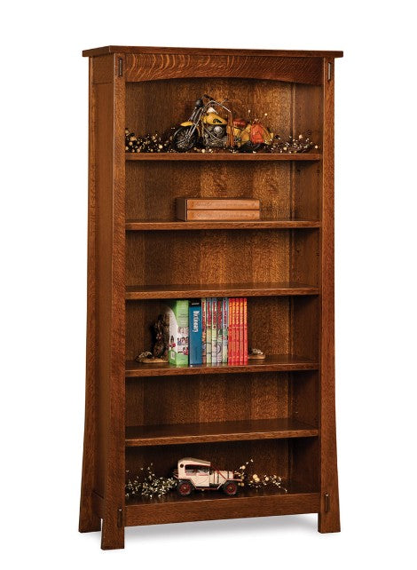 A tall, five-shelf wooden bookcase with a warm medium-brown finish, styled with books, a motorcycle figurine, and a small vintage car on a white background.