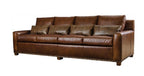 Brown leather sofa with decorative pillows on a white background