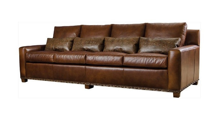 Brown leather sofa with decorative pillows on a white background