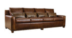 Brown leather sofa with decorative pillows on a white background