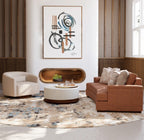 Modern living room with brown sofa, beige armchair, and abstract artwork on the wall.