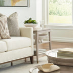 Modern living room with a white sofa, coffee table, and decorative items.