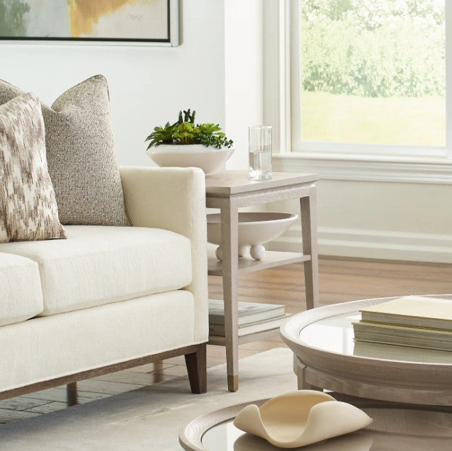 Modern living room with a white sofa, coffee table, and decorative items.